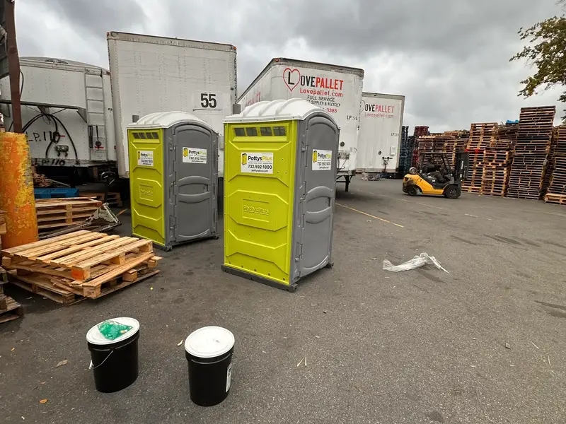 Multiple PottysPlus porta potty units deployed at a New Jersey construction job site