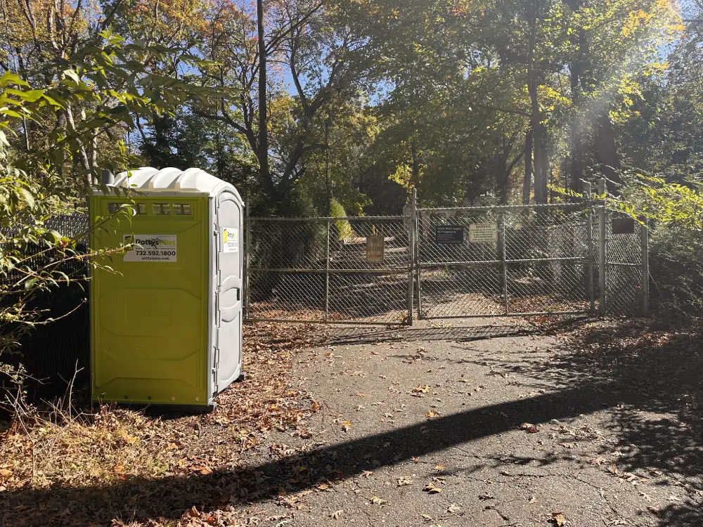 Portable toilet used for a long term rental at a fenced site.
