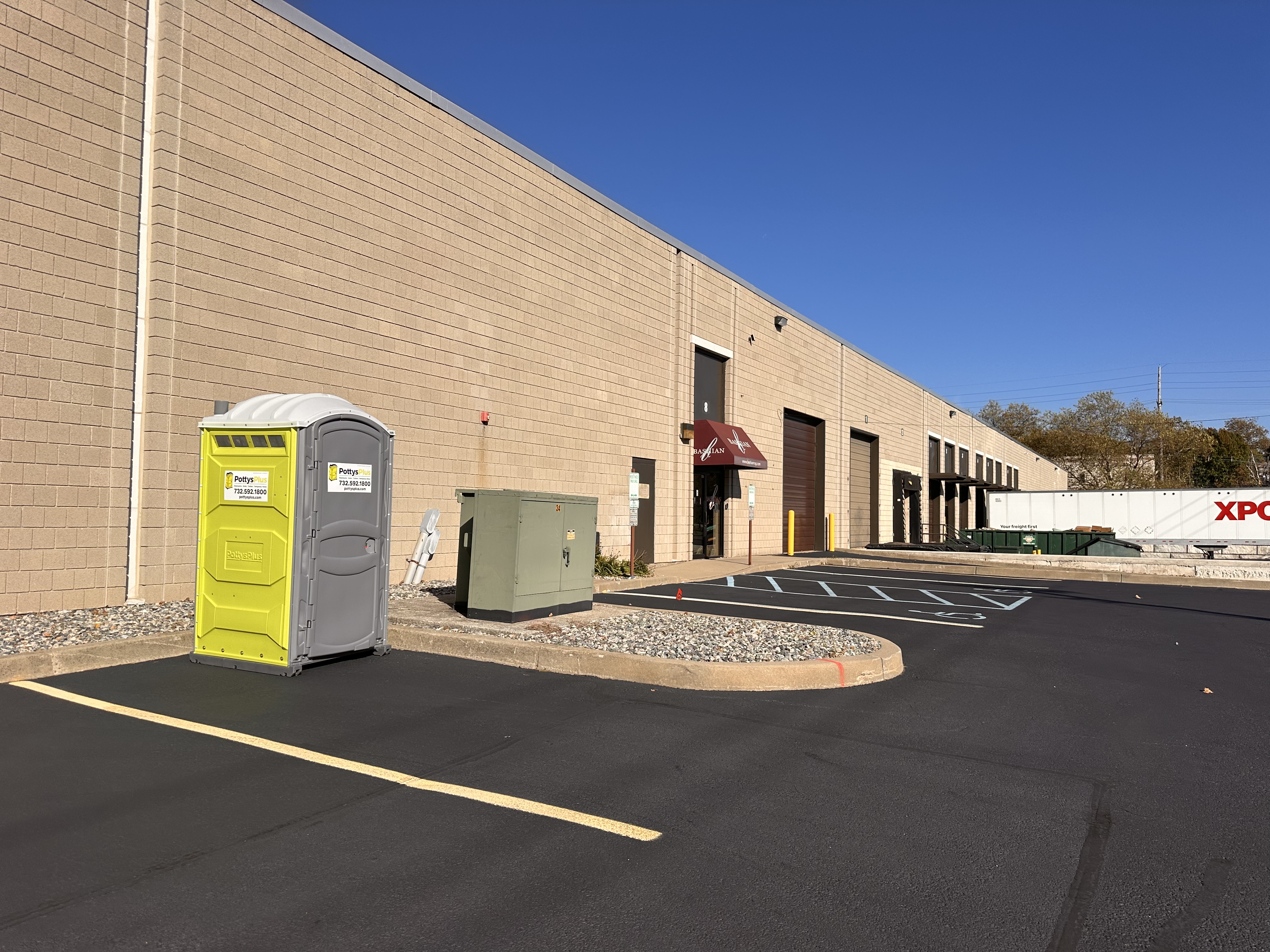 Portable restroom trailer setup at outdoor event in Newark