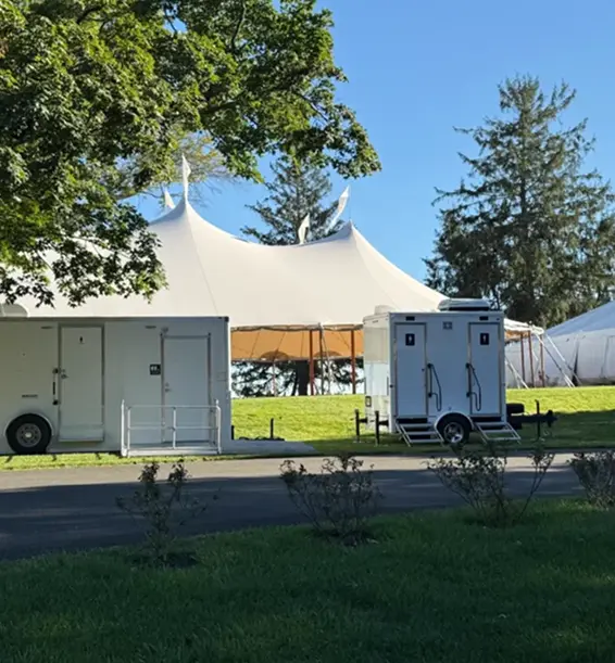 Portable restroom trailer setup at outdoor event in Newark